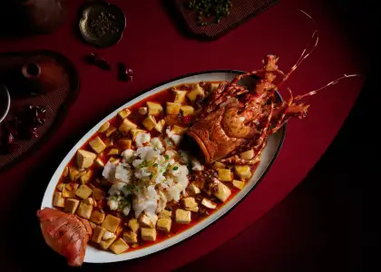 Mapo Tofu with Lobster is an elevated version of the Sichuan staple, with a full lobster and silky tofu in spiced red oil.