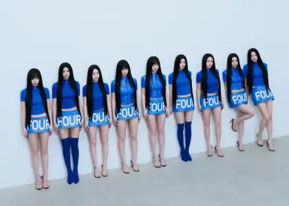 The nine members of TWICE in matching, blue outfits
