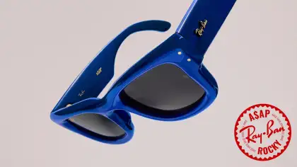 Dark blue sunglasses against a neutral background