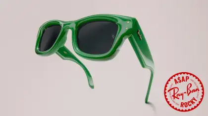 Green sunglasses against a neutral background