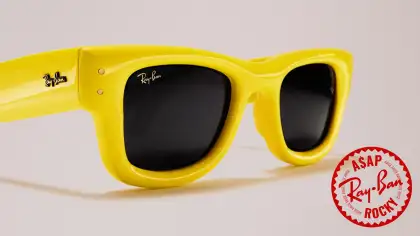 Yellow sunglasses against a neutral background