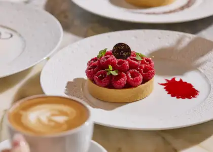 A custard tart topped with raspberries on top