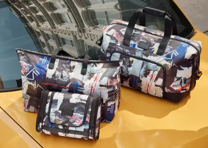 Bags on top of a yellow taxi