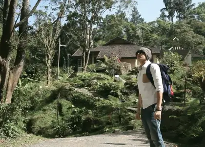 A man surrounded by greenery