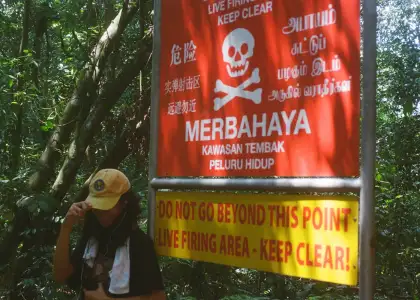 a picture of an artist with a poster beside him