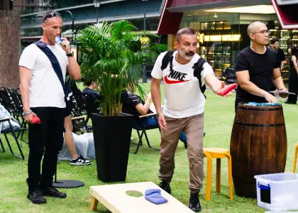 men playing cornhole