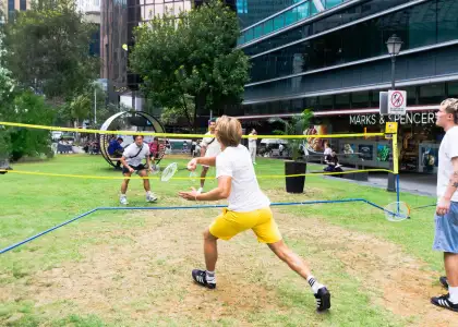 a group of people playing badminton