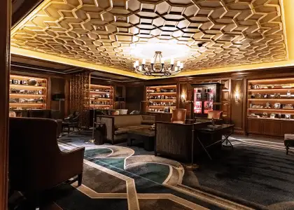 A lit bar with touches of velvet, gold, and vintage interiors.