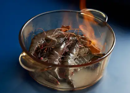 A bowl of shrimp with fire