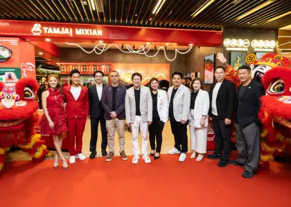 People in front of a store opening with lucky lions on both sides
