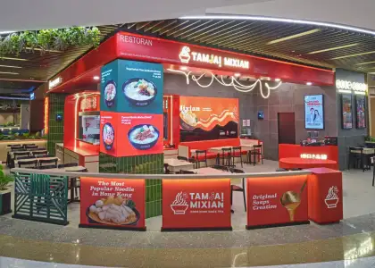 A storefront with a red and green color scheme with neon lights