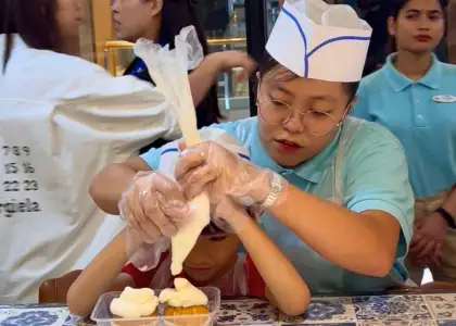 StarCruises’ “Star Voyager” crew member teaching child guest cooking