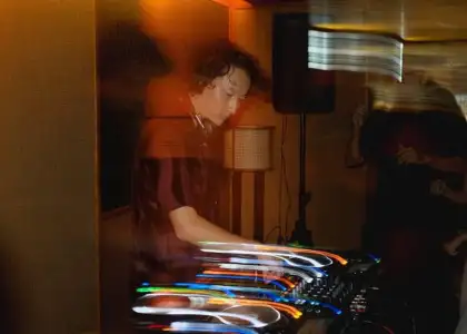 Musician Bolis Pupul on the deck at a Terrible Baby party