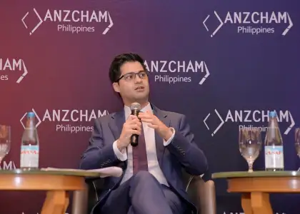 A man speaking with a microphone