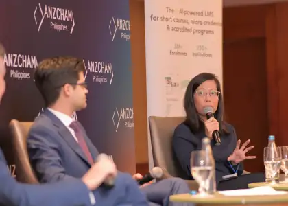 A woman speaking with a microphone