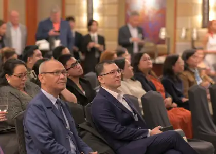 Two men listening to the panel discussion