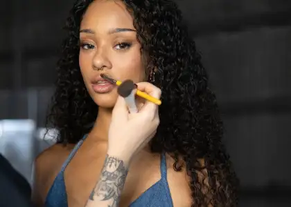 KATSEYE member Manon getting makeup done for Gap video shoot