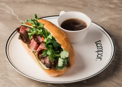 a sandwich with a side of coffee