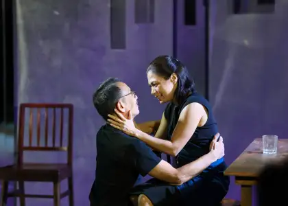 A woman caressing a man's face