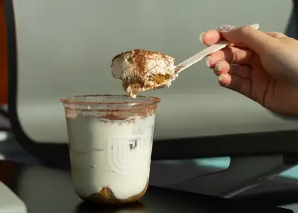 A tiramisu in a plastic cup