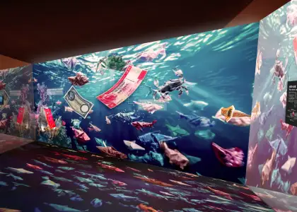 Origami banknotes swim through a digital seascape