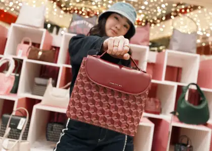A photo of Christy Ng with the Julio Backpack in Burgundy