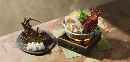 A lobster prepared in two ways: sashimi and hot pot