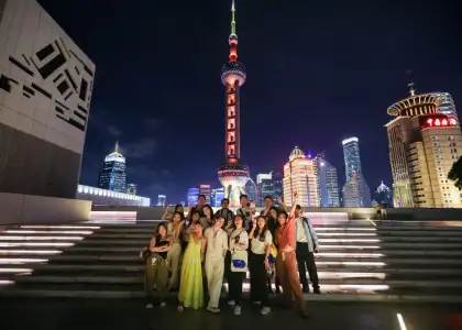Tour group from Hong Kong posing in front of Oriental Pearl Tower in Shanghai