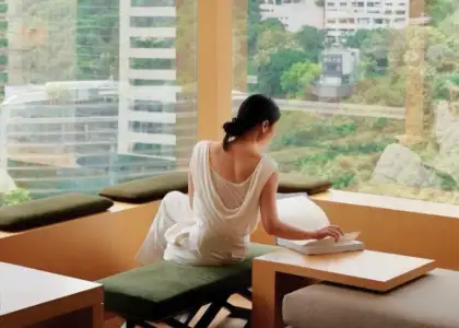 Upper House Room Interior elegantly dressed woman enjoying views of Hong Kong