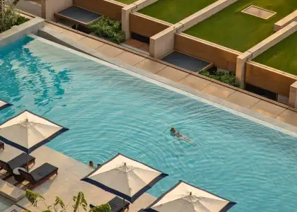 Woman swimming in Capella Bangkok's outdoor pool
