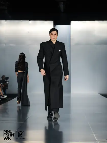 A male model with a long black coat