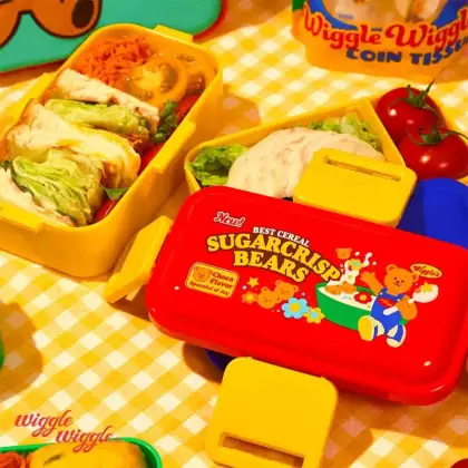 A lunchbox with yellow gingham picnic mat