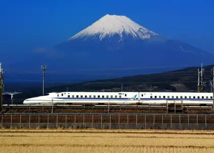 A photo of the Shinkansen traveling across Mt. Fuji in Japan