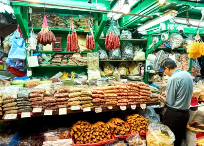 Photo of a man buying dried goods in a local market