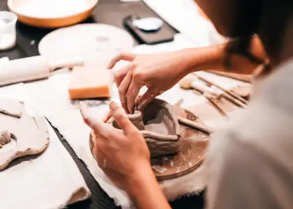 A photo of a woman taking pottery classes
