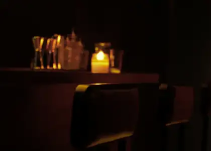 Low-lit bar table with a candle in the middle