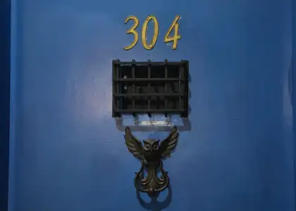 A blue door with an antique door knocker