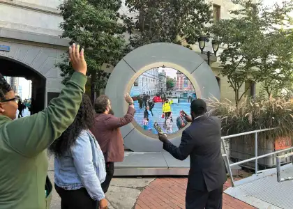 People looking at the portal sculpture