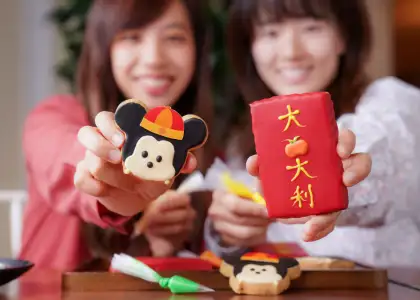 A photo of two girls decorating cookies