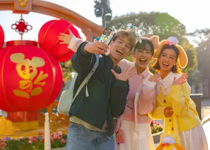 A photo of three people at Hong Kong Disneyland