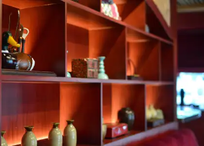 A shelf lined with traditional Chinese tea sets