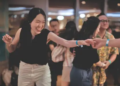 A woman smiling while dancing