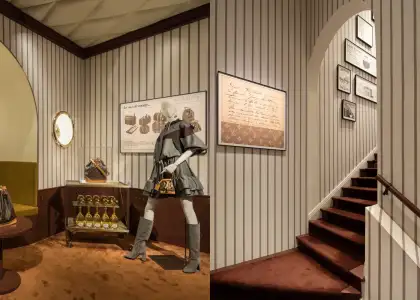 A manequin dressed in Louis Vuitton with a Noe bag and a staircase