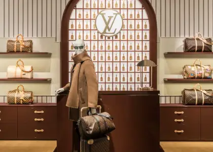 A mannequin dressed in Louis Vuitton with iconic Monogram Keepall silhouette bag