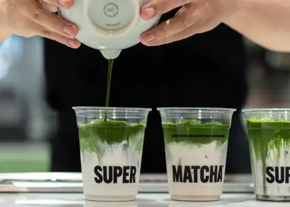 Matcha being poured into a cup with the brand name