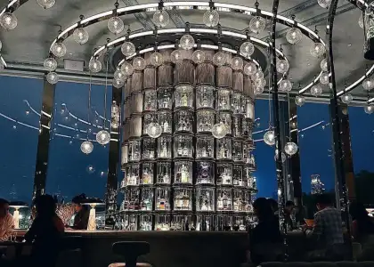 A large shelf filled with bottles of spirits