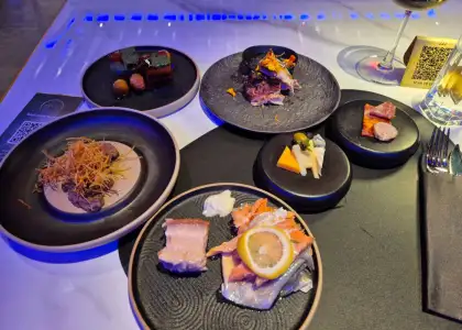 Food on different plates on a white marble table