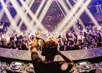 A DJ heading a party in the club