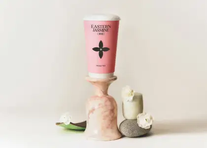 A pink cup with tea inside