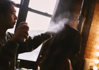 Celebrity hairstylist Paul Nebres styling a model's hair